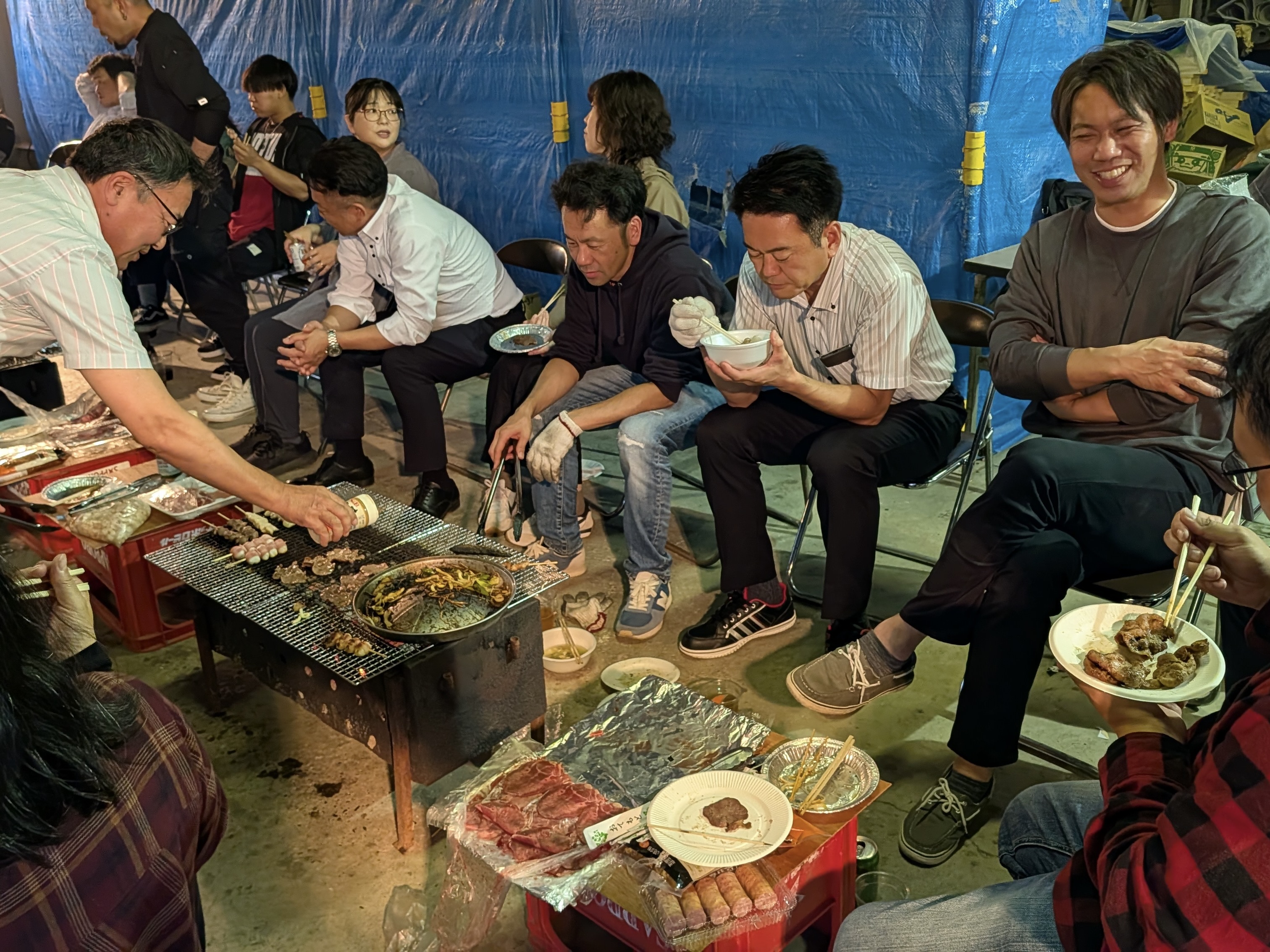 【社風・雰囲気】 
資材センターでのBBQの写真です。社内の雰囲気はとても温か。仕事するときはプロとして厳格に、オフは家族のように支え合う。そんなメリハリのある組織です。